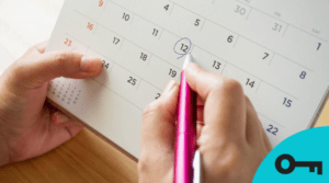 Une main qui encercle une date sur un calendrier.